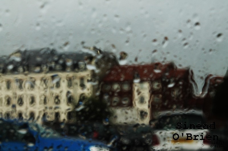 buildings through a window in the rain