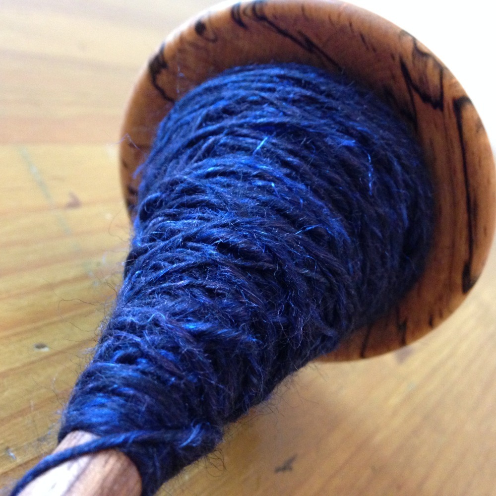 Handspun silky sky blue yarn on drop spindle