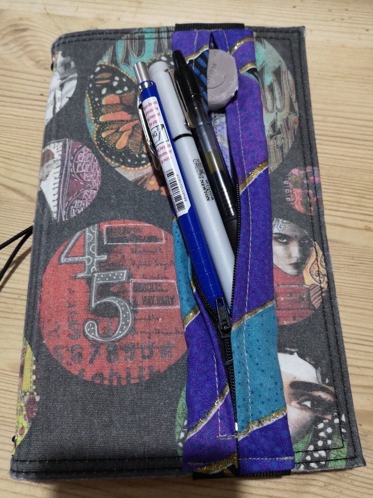 DIY notebook pen holder on notebook with pens sticking out
